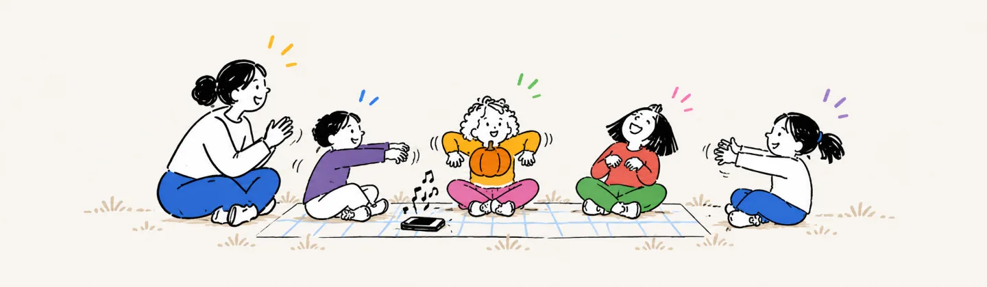 A grown-up and four kids sit in a circle on a picnic blanket passing a small pumpkin with stiff zombie arms while a phone plays music