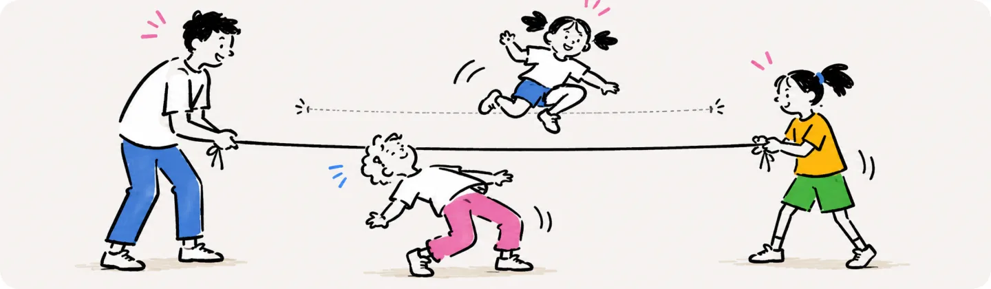 Two players hold the rope while one kid leaps over it and another ducks under