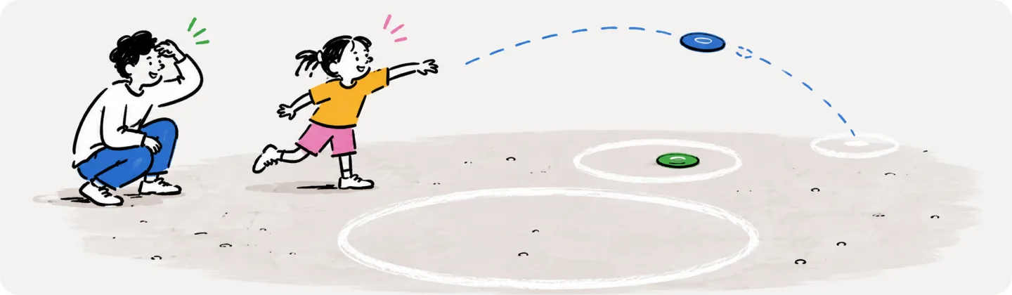 A kid flings a disc along a dotted arc toward chalked circles while a crouching parent watches